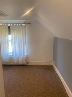 A well-maintained bedroom with a large window a...