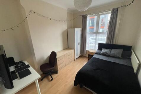 A bright and welcoming double bedroom featuring...