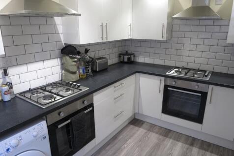 Modern and well-maintained kitchen with white c...