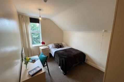 A cozy double bedroom with natural light stream...