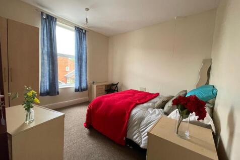A well-maintained bedroom featuring a single be...
