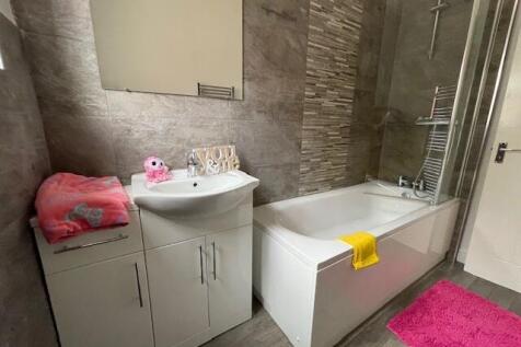 Modern bathroom featuring a spacious bathtub, s...
