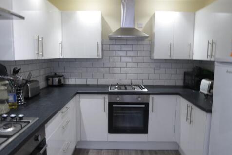 Modern, well-maintained kitchen featuring white...