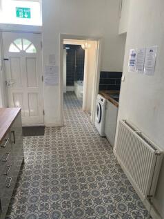 A modest kitchen area with patterned flooring, ...