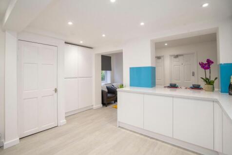 A modern kitchen with bright lighting and clean...