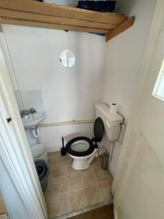 Compact bathroom with basic fixtures, including...