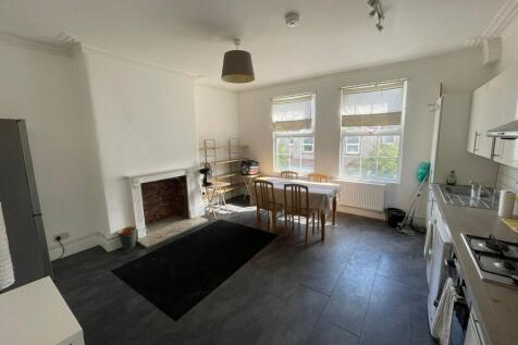 Bright and spacious living area with large wind...