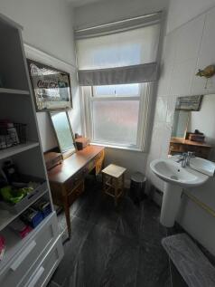 Bright and clean bathroom featuring a pedestal ...