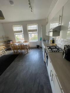 A well-lit, modern kitchen featuring a spacious...