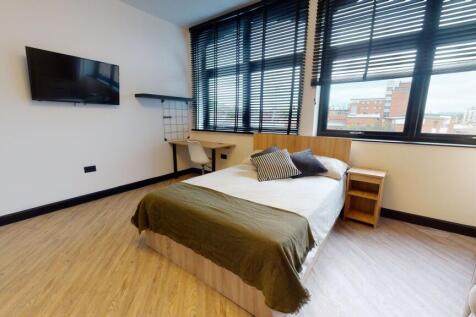 A bright, modern bedroom featuring a large wind...