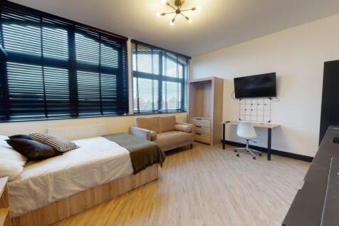 Bright and spacious living room with large wind...