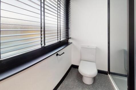 Modern bathroom featuring a white toilet, a fro...