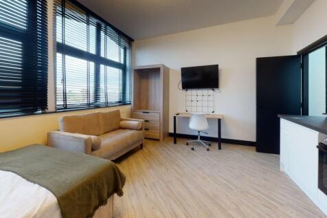 Bright and spacious living room featuring large...