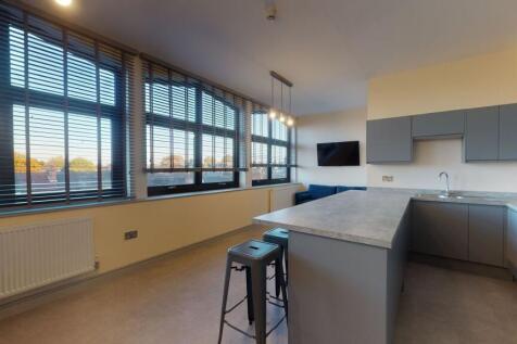 Bright and modern living room featuring large w...