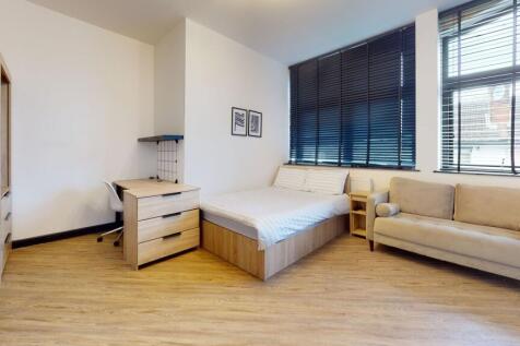 Bright and modern student bedroom featuring a s...