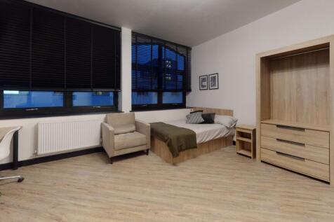 Modern and bright bedroom featuring large windo...