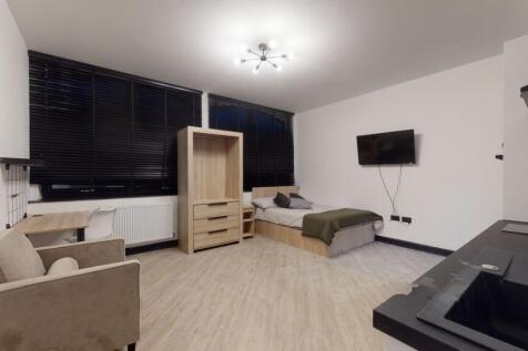 A modern, well-lit living room featuring large ...