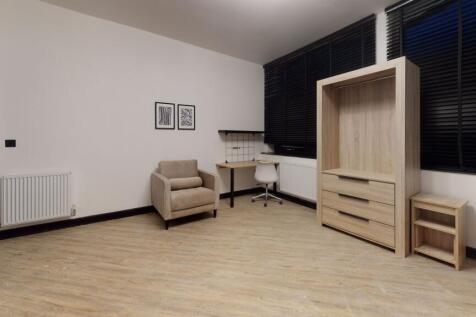 Modern and spacious living area featuring neutr...