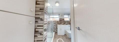 Modern bathroom featuring a large shower, a sle...