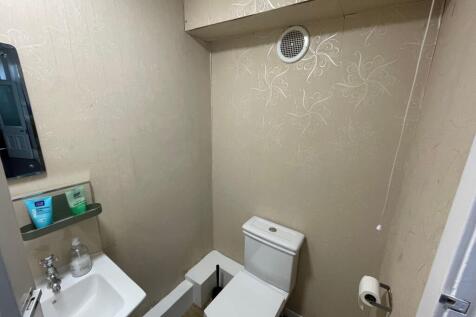A compact and functional bathroom featuring a t...