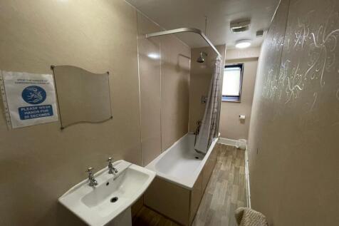 A clean, functional bathroom featuring a bathtu...