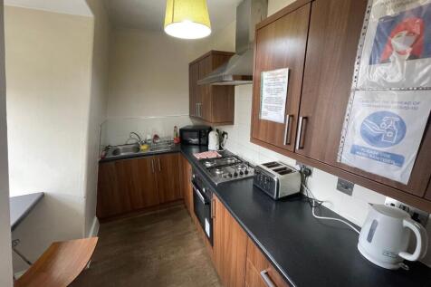 A well-equipped kitchen with wooden cabinets, b...