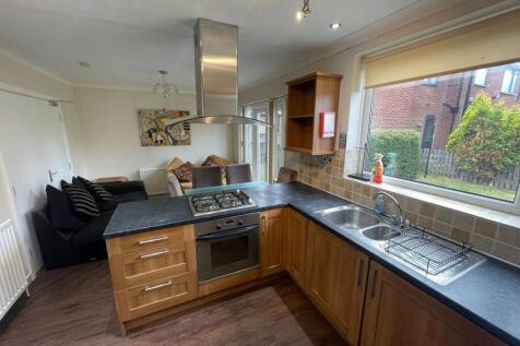 Bright and modern kitchen with ample natural li...