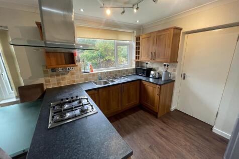 A well-maintained kitchen featuring wooden cabi...