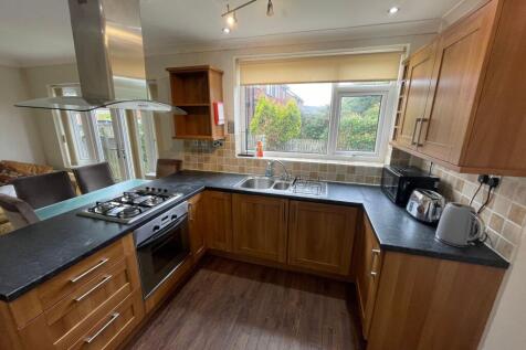 Bright and well-equipped kitchen featuring wood...