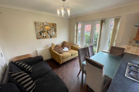A welcoming living room filled with natural lig...