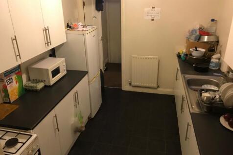 A compact, functional kitchen with white cabine...