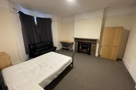 Spacious double bedroom featuring a cozy seatin...