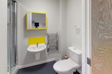 A modern bathroom featuring a toilet and a sink...