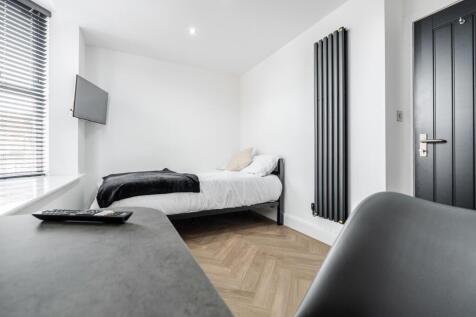 A bright and modern master bedroom featuring a ...