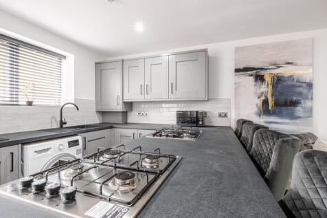Modern and well-maintained kitchen featuring sl...