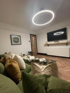 A stylish, contemporary living room featuring a...