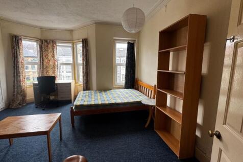 Bright single bedroom featuring three large win...