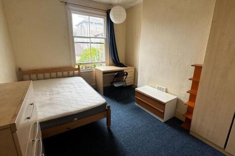 Bright and straightforward bedroom with a large...