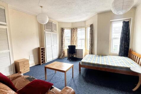 Bright and inviting living room with large wind...