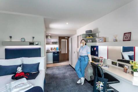 A modern and inviting master bedroom featuring ...