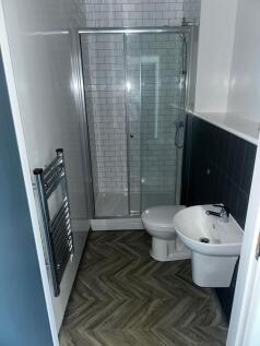 Modern bathroom featuring a shower enclosure wi...