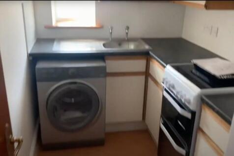 A compact kitchen with essential appliances, in...