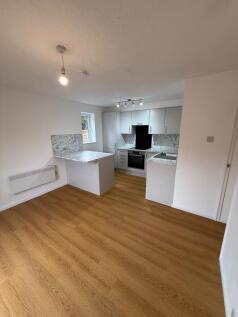 Modern and bright kitchen featuring white cabin...