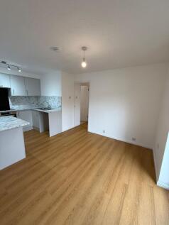 Bright and spacious living room featuring a cle...