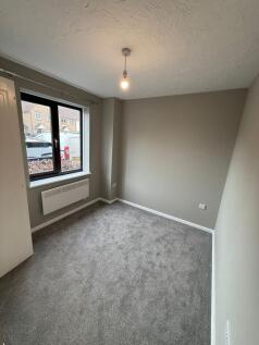 A well-maintained, bright bedroom with a large ...