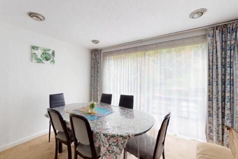 A bright and welcoming living room with a large...