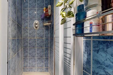 A clean and bright bathroom featuring a spaciou...