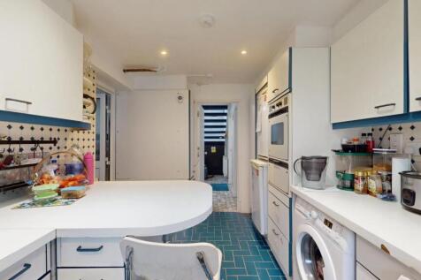 Bright and modern kitchen with ample workspace,...