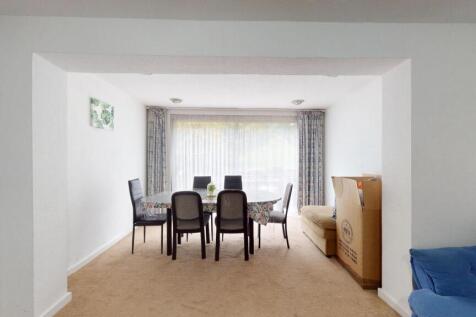 A well-lit, spacious living room featuring mode...
