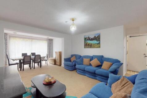 Bright and spacious living room featuring large...